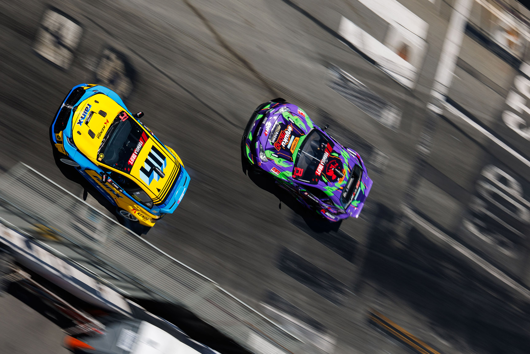 Overhead view of two drift cars running tandem on the Long Beach course.