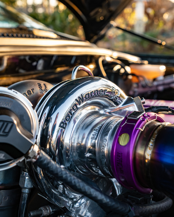 Close-up of the BorgWarner EFR turbocharger and titanium piping in Leopold Barrit’s twin-turbo 1995 Toyota Supra engine bay.