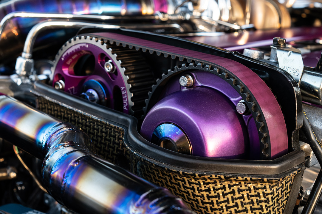 Close-up of Hypertune cam gears and titanium piping in the twin-turbo 2JZ engine bay of Leopold Barrit’s 1995 Toyota Supra.