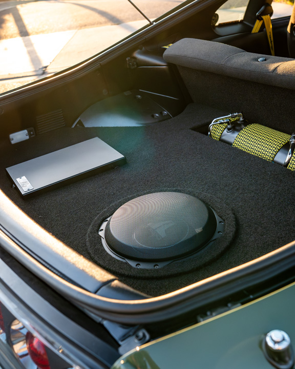 Custom trunk audio setup in Leopold Barrit’s 1995 Toyota Supra featuring a JL Audio subwoofer and clean upholstered enclosure.