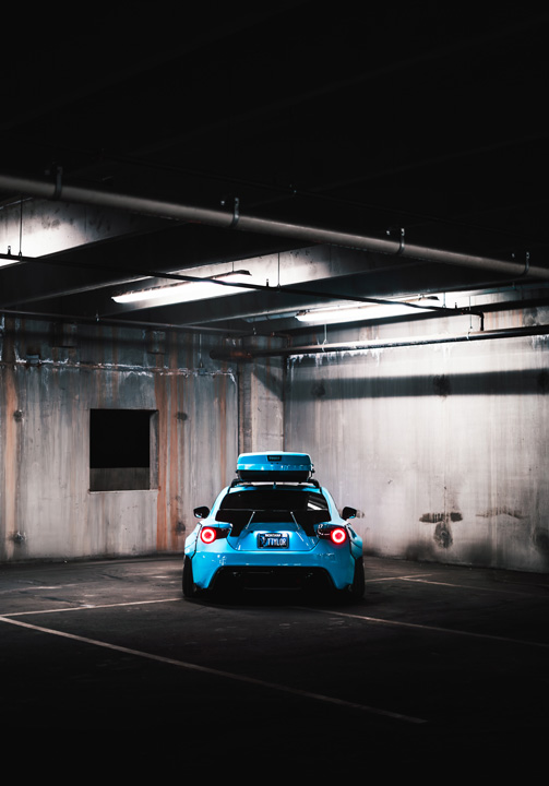 Side profile of Nicholas Sargeant’s widebody Scion FR-S with roof-mounted ski box inside a parking garage.