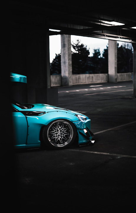 Nicholas Sargeant’s Scion FR-S featuring Rocket Bunny widebody styling and Thule ski box inside a parking garage.