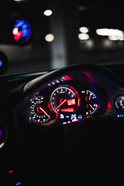 Illuminated gauge cluster inside Nicholas Sargeant’s 2016 Scion FR-S parked inside a dimly lit garage.