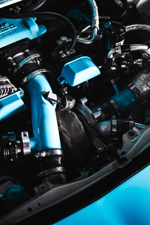 Close-up detail of the turbo system and custom piping inside Nicholas Sargeant’s Scion FR-S engine bay.