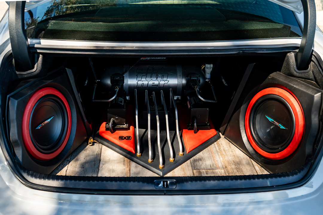 Custom trunk audio setup in Dana Balthasar’s Lexus RC F with subwoofers and Air Runner suspension components.