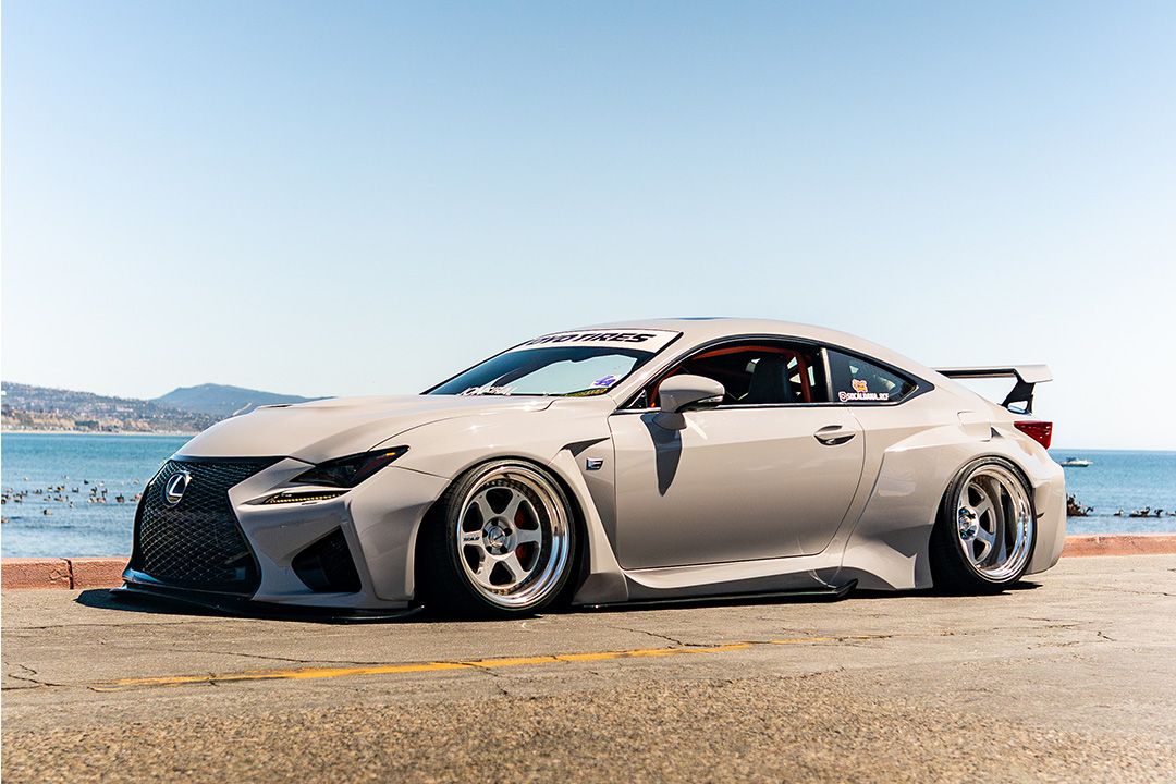 Dana Balthasar’s gray widebody Lexus RC F parked along the coast with ocean views in the background.