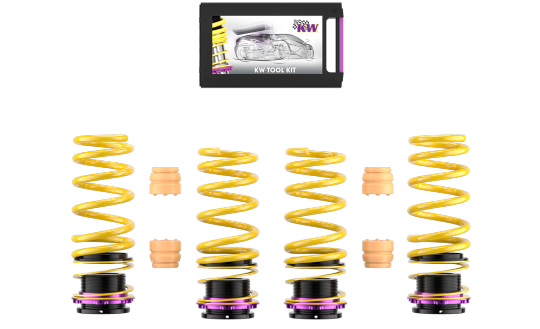 KW height-adjustable spring kit components for the BMW M5, including springs, threaded sleeves, bump stops, and tool kit.