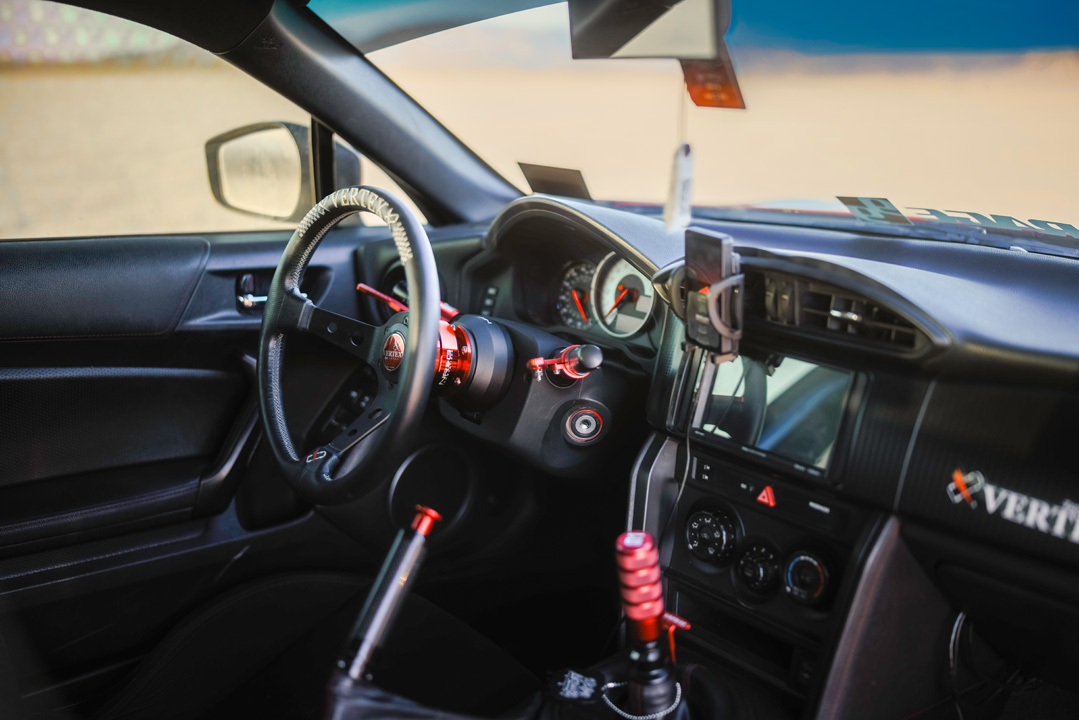 Interior detail of Anthony Gonzales’ Scion FR-S showing the Vertex steering wheel, WeAreLikewise shift knob, and carbon fiber handbrake.
