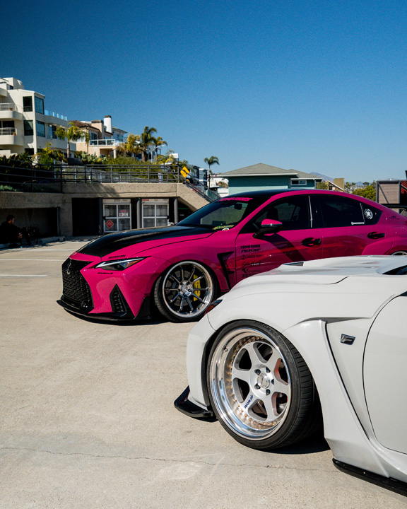 Dana Balthasar’s gray Lexus RC F and Giuseppe Balthasar’s pink Lexus IS 500 parked together on a rooftop.