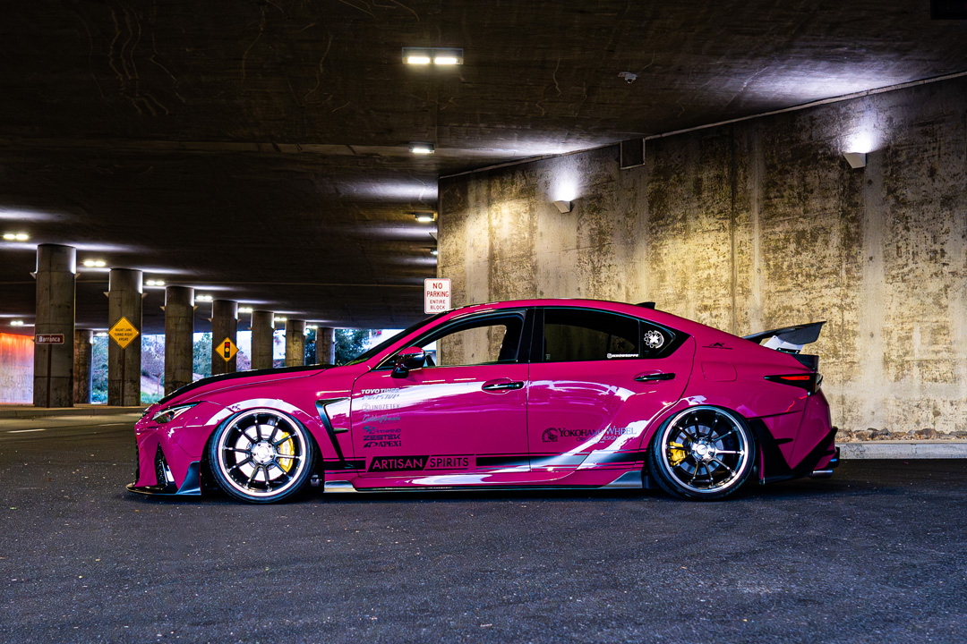 Side profile of Giuseppe Balthasar’s pink widebody Lexus IS 500 showing the Artisan Spirits kit and Advan wheels.