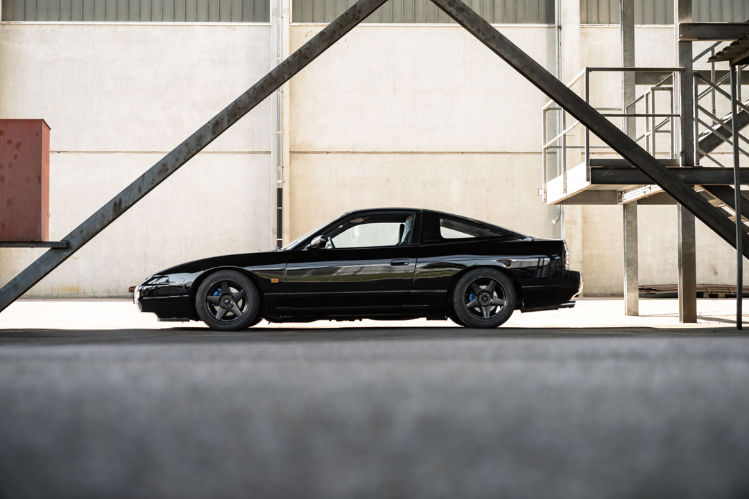 Black Nissan S13 shown in side profile with a lowered stance on ST XTA plus 3 coilovers.
