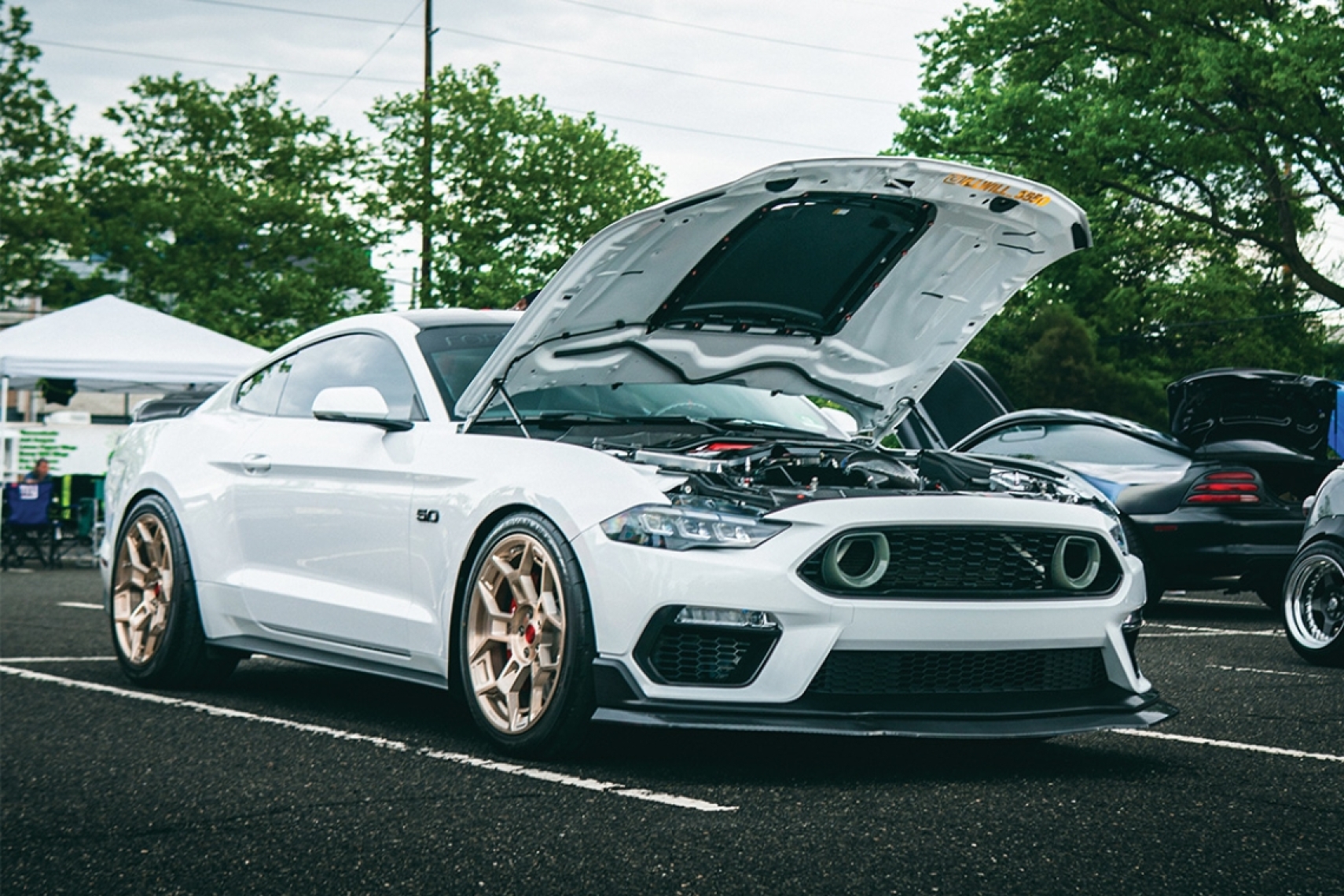 William Howard's white 2018 Ford Mustang GT displayed with the hood open at the Tuning 365 Tour stop at Formula Drift Englishtown.