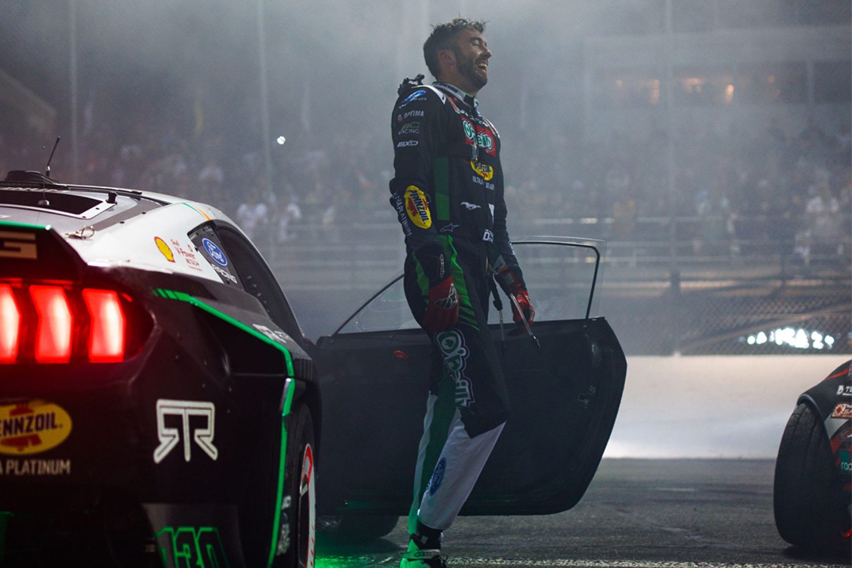 James Deane celebrates beside his O'Reilly / Pennzoil Ford Mustang RTR after winning Formula DRIFT Round 4 at Stafford Motor Speedway in 2026.