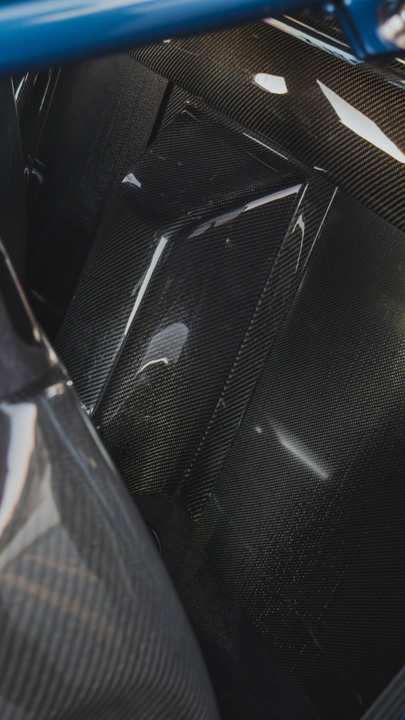 Interior detail of Peter Doan’s 1991 Honda NSX showing the carbon interior paneling behind the seats and blue Cusco roll cage.