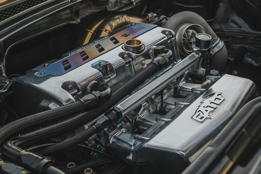 Engine bay detail of Peter Doan’s 1991 Honda NSX showing the built K24 turbo setup, GATO intake manifold, titanium hardware, and custom fabrication.
