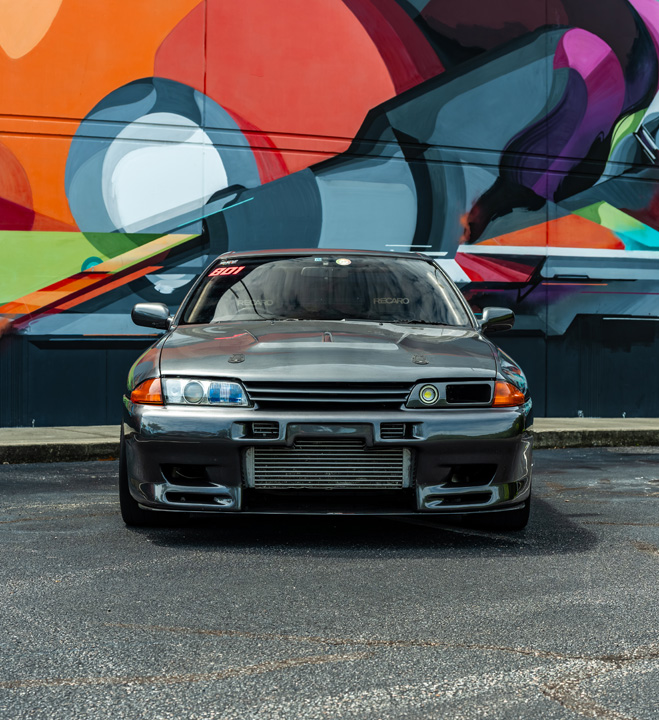 Cee Vann’s gray 1990 Nissan Skyline GT-R with high-horsepower RB30 setup, drag-focused details, and race-ready exterior and interior upgrades.