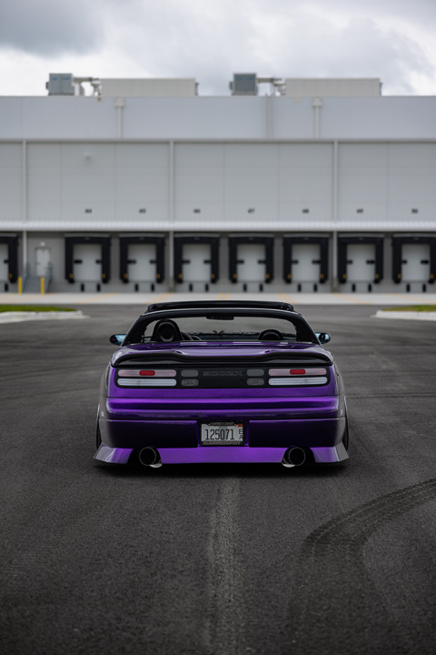 Rear view of Alex Hammond’s purple 1993 Nissan 300ZX Convertible showing the custom rear bumper, dual exhaust, clear tail lights, and low stance.