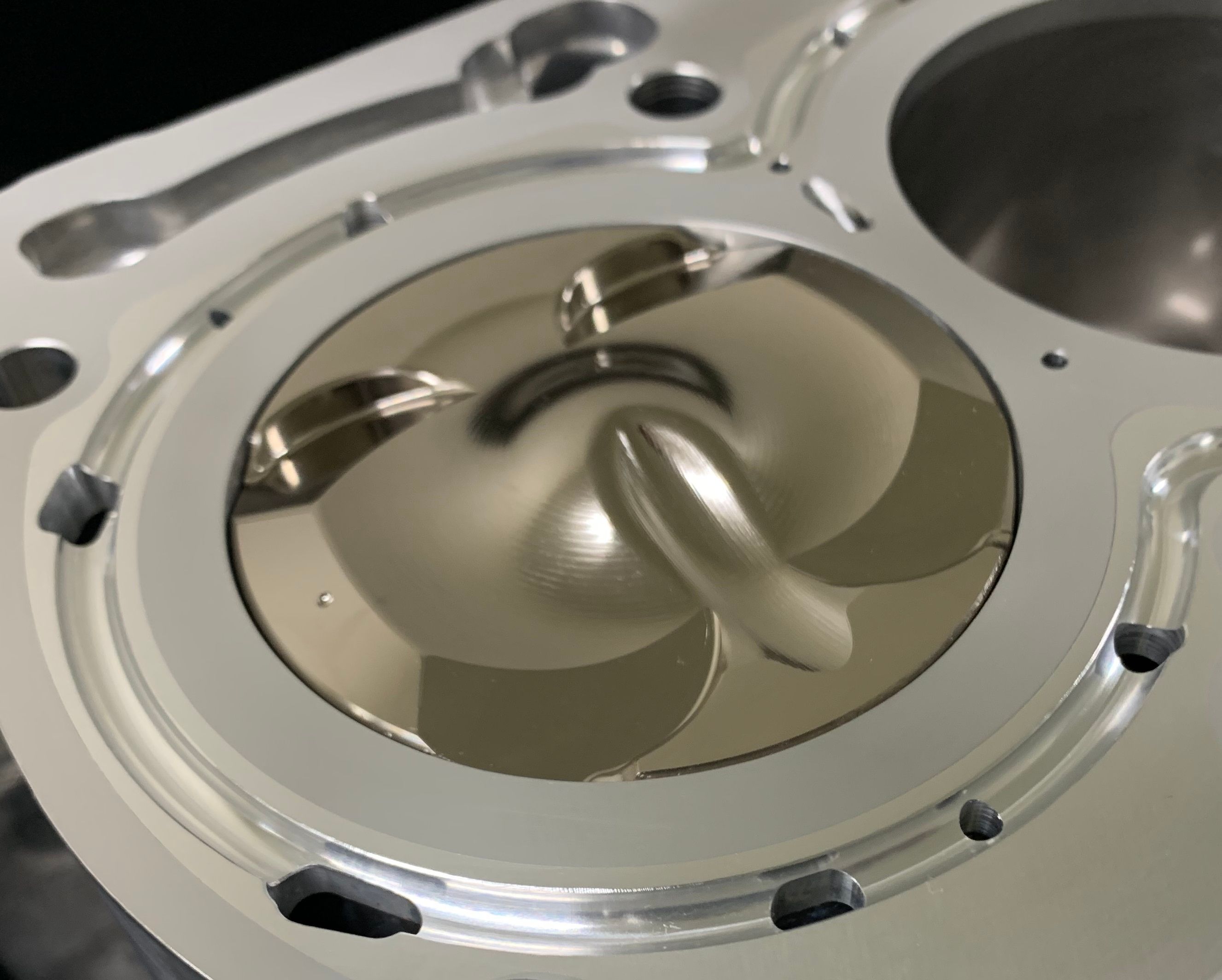 Close-up of the HKS G16E low-compression BCD piston installed in the closed-deck short block.