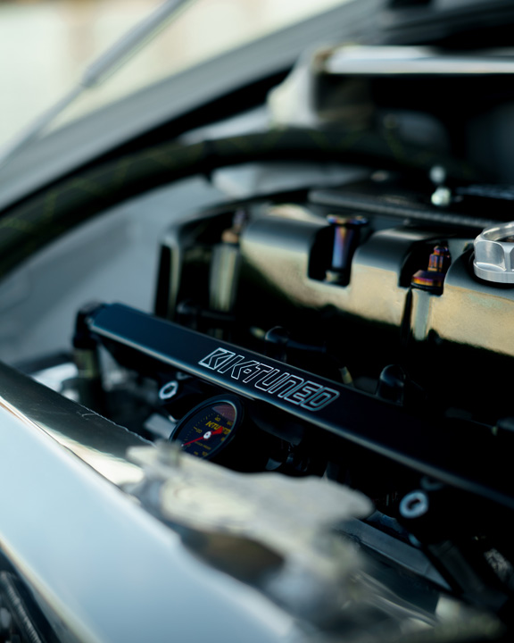 Jonathan Ortiz’s 2005 Acura RSX Type-S with Porsche PTS Fashion Grey paint, Mugen aero, J’s Racing details, blue Volk Racing CE28N wheels, turbocharged K-series engine bay, DC5R interior conversion, and Sony ES audio setup.