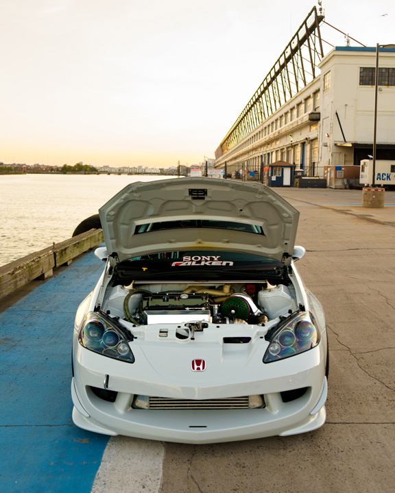 Jonathan Ortiz’s 2005 Acura RSX Type-S with Porsche PTS Fashion Grey paint, Mugen aero, J’s Racing details, blue Volk Racing CE28N wheels, turbocharged K-series engine bay, DC5R interior conversion, and Sony ES audio setup.