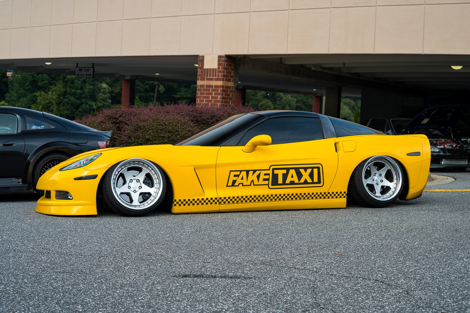 Yellow lowered Chevrolet Corvette with Fake Taxi graphics at Daikoku Tensei Style 2026 in Hickory, North Carolina.