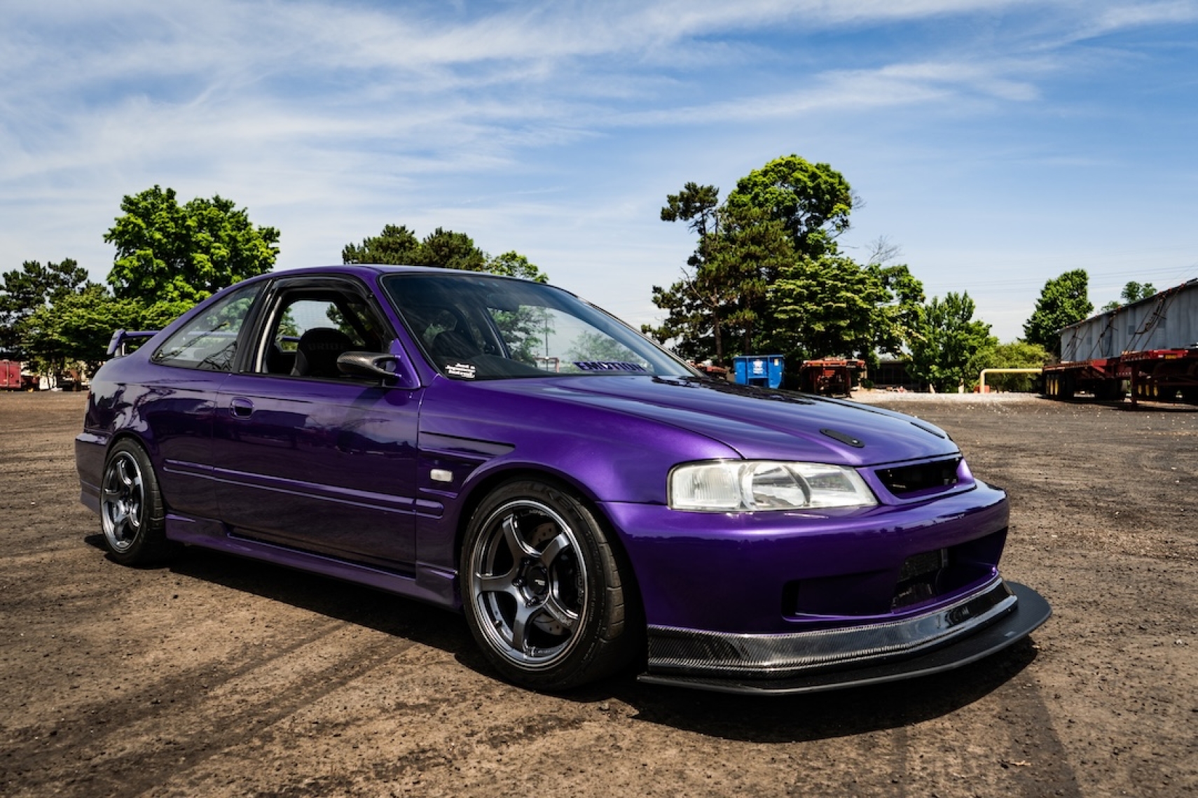 Front three-quarter view of Brandon Elste’s 1996 Honda Civic showing its Plum Crazy paint, Honda Domani front-end conversion, ADVAN Racing TC-4 wheels, and Racebred front splitter.