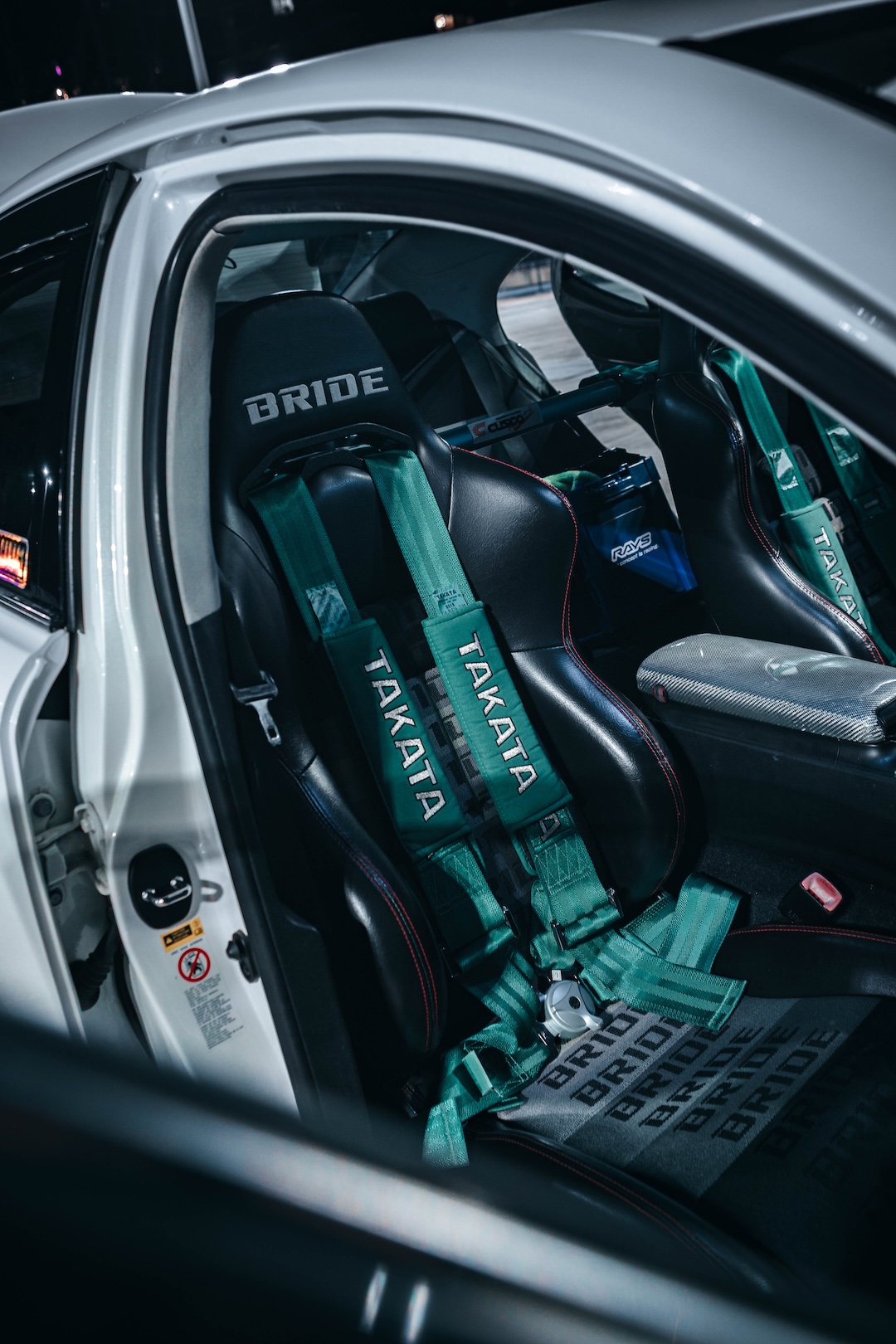 Interior of Harry Nguyen’s 2006 Lexus IS350 showing a Bride XAX II seat, Takata four-point harness, and Cusco harness bar.