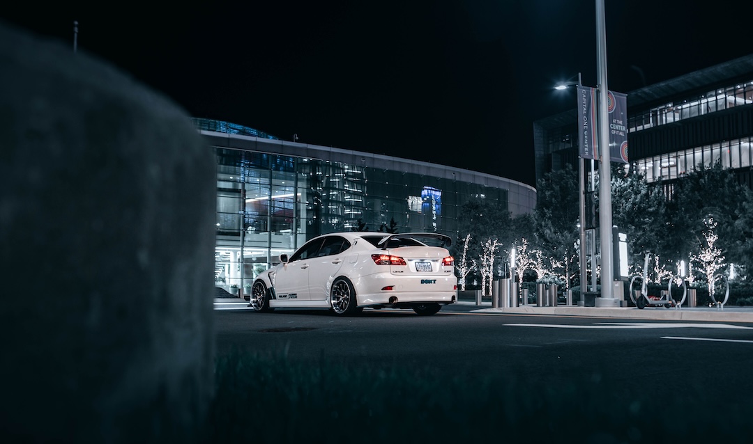 Rear three-quarter view of Harry Nguyen’s 2006 Lexus IS350 showing its JDM IS F taillights, SARD rear spoiler, Vertex Digna rear apron, and Volk Racing LE28N wheels.