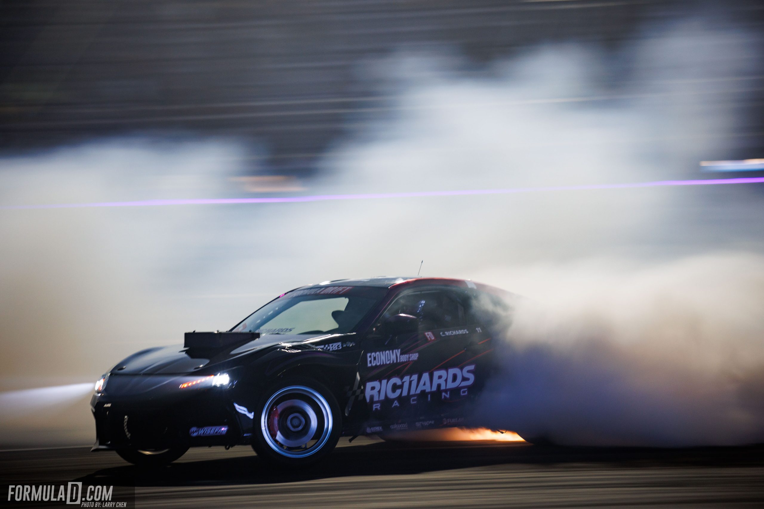 Cole Richards drifts through tire smoke during Formula Drift Round 7 at Las Vegas Motor Speedway.
