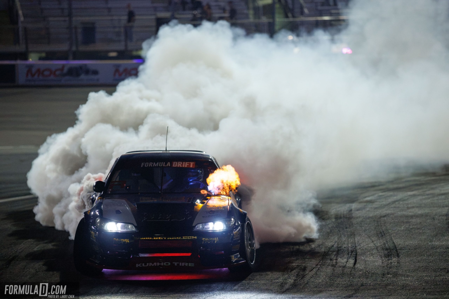 Formula Drift competition car surrounded by tire smoke during Round 7 at Las Vegas Motor Speedway.