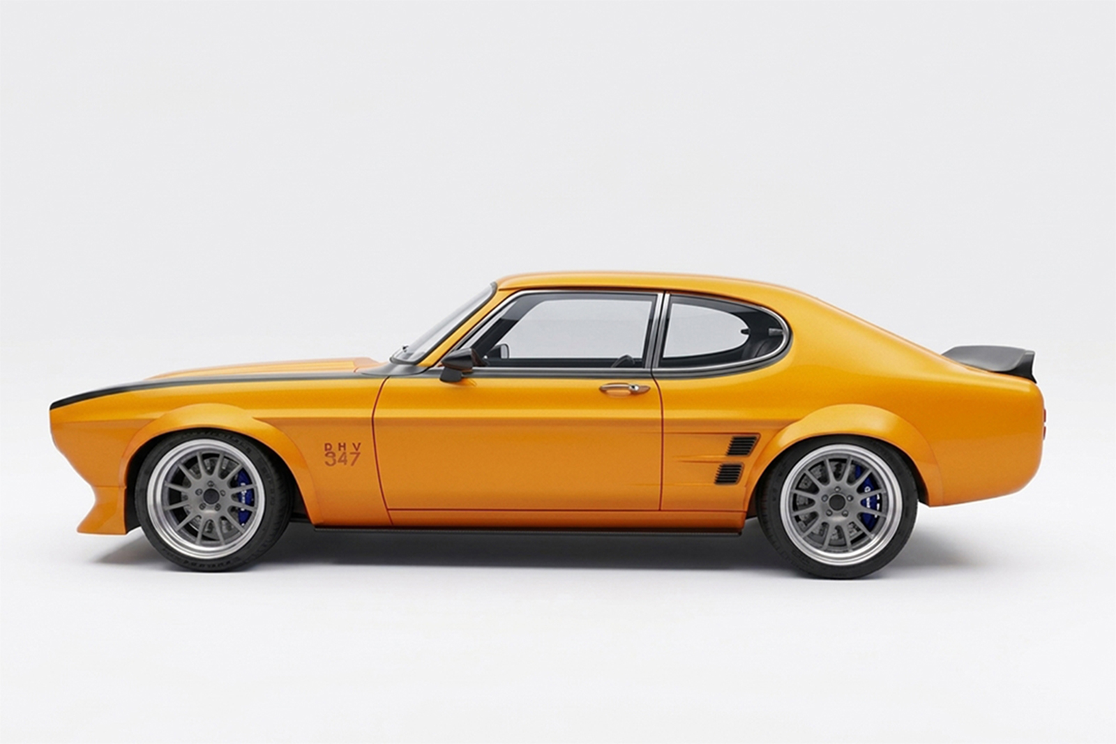 Side profile of the 1974 Ford Capri Mk1 by JH Restorations, featuring Papaya Spark orange paint, custom widebody, silver American Racing wheels and a rear spoiler.