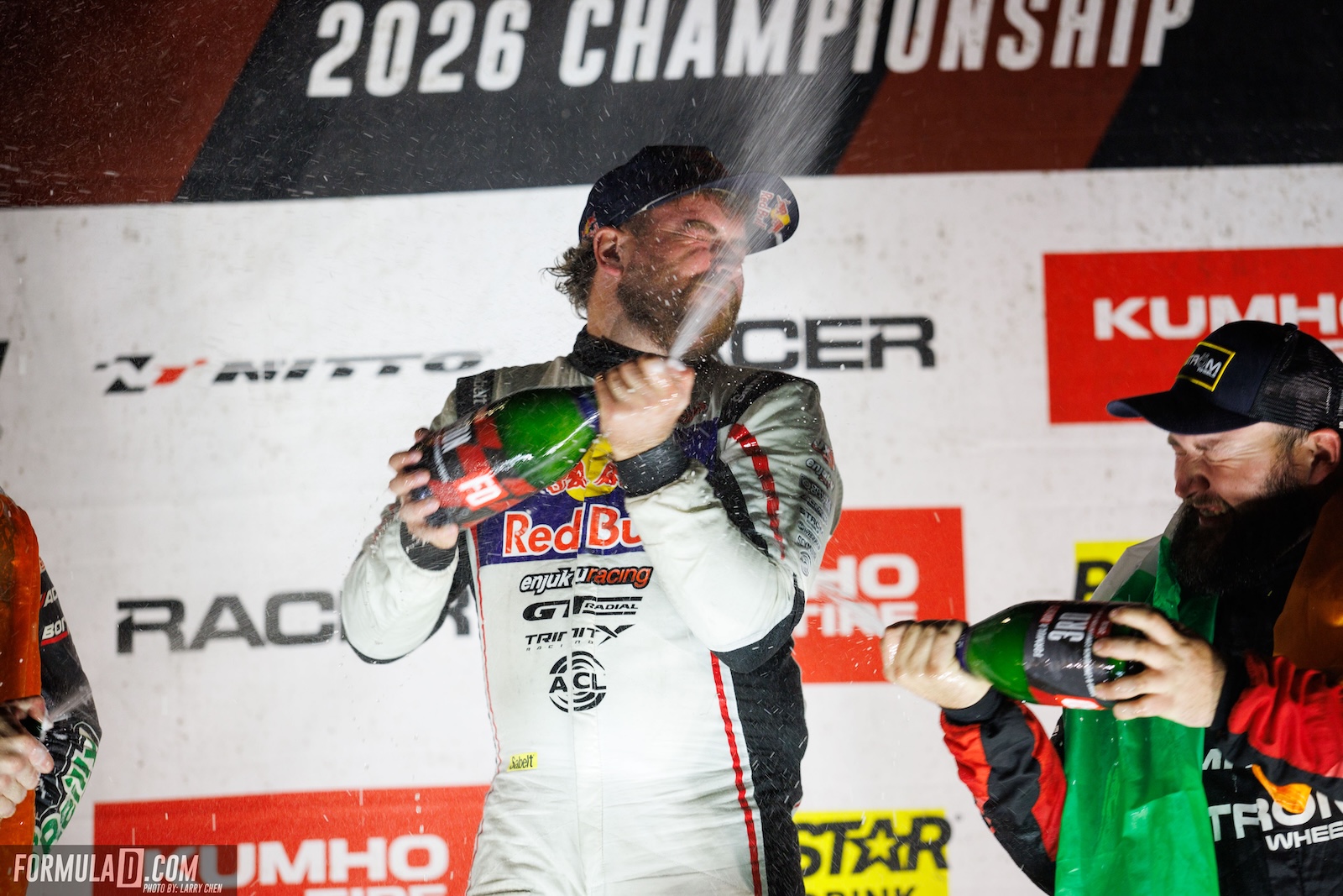 2026 Formula Drift PRO Champion Conor Shanahan celebrates with champagne on the podium following the season finale at Long Beach, California.