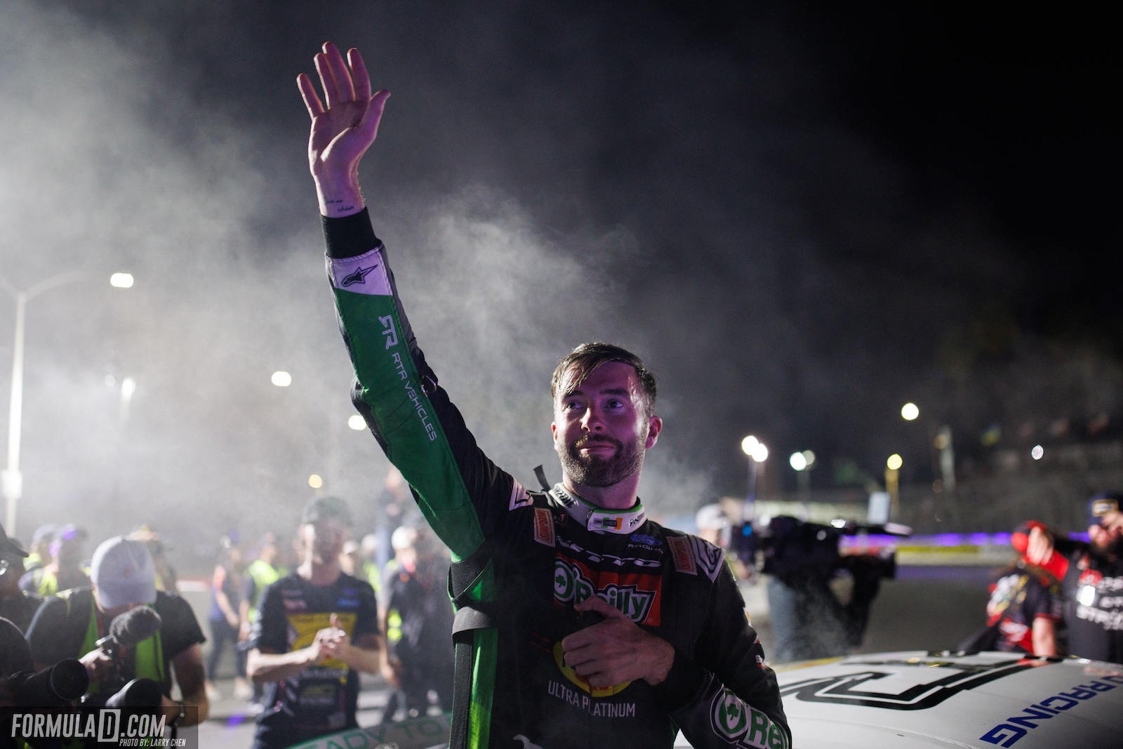 James Deane raises his hand in celebration after winning Round 8 of the 2026 Formula Drift PRO Championship in Long Beach, California.