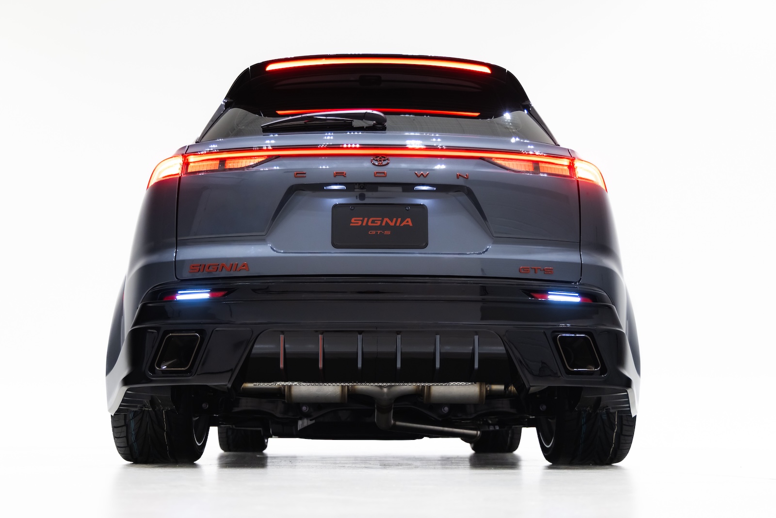 Rear view of the Toyota Crown Signia GT-S Concept featuring illuminated LED taillights, widened bodywork, custom rear diffuser and integrated trapezoidal exhaust tips.